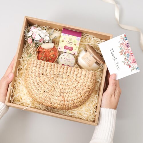 Care package gift box comes with straw purse, cherry lip balm and soy candle. personalised card