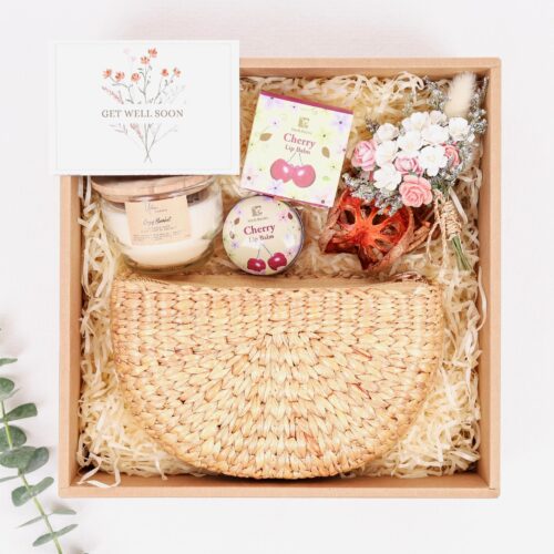 Care gift box comes with straw purse, cherry lip balm and soy candle. personalised card